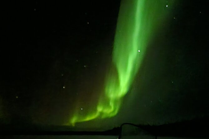 An Evening in the Backcountry, Northern Lights on a Sleighride - A campfire while the sky makes up its mind