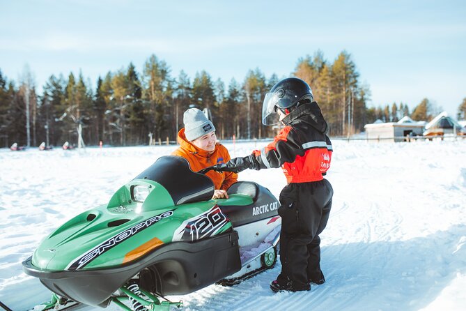 Family Snowmobiling in Rovaniemi, Apukka Resort - Riding into Apukka’s snowy forest