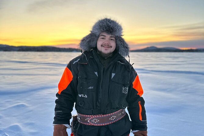 From Saariselkä: Ice Fishing Tour to Lake Inari, reindeers &lunch - Riding a snowmobile-pulled sled across the ice
