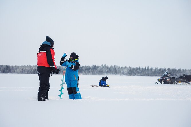 Ice Fishing and Snowmobile Safari Combo in Lapland - Sausages and drinks beside the campfire