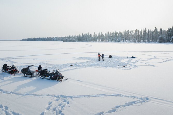 Ice Fishing and Snowmobile Safari Combo in Lapland - Riding through the forest and onto the frozen lake