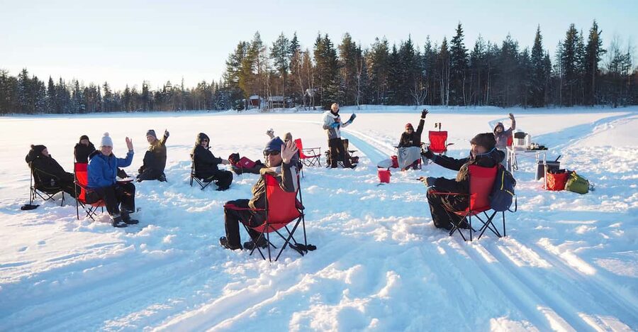 Ice fishing program in Lapland - Fire, food, and a useful warm-up