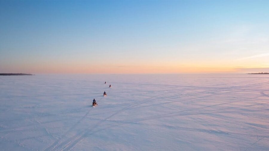Kemi-Tornio: Ice Fishing Safari with Snowmobiles - Drilling the ice and setting up your fishing hole