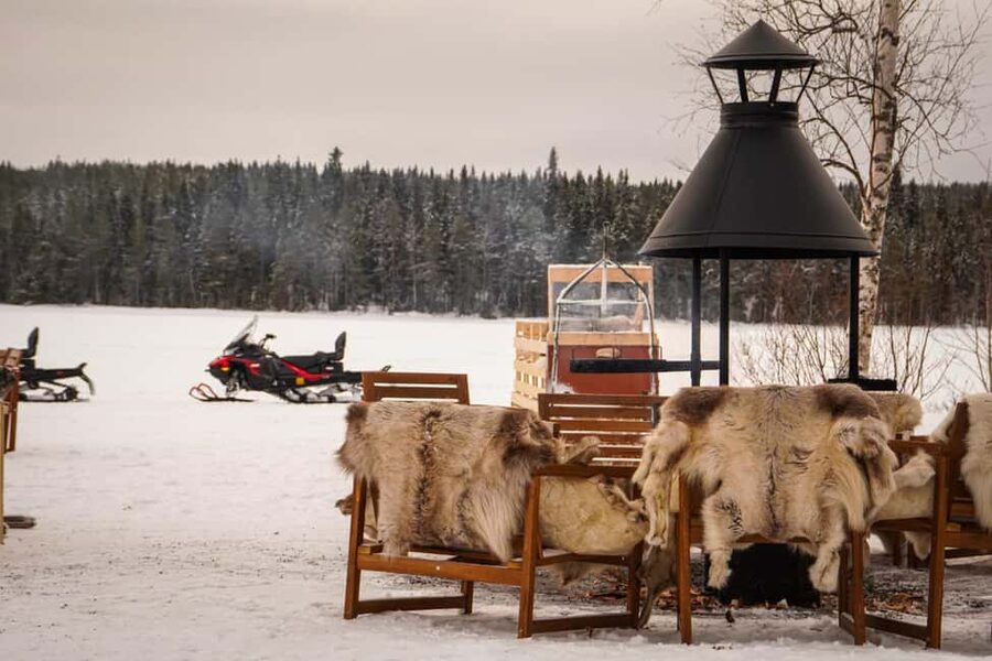 Rovaniemi: Guided Wilderness Snowmobile Safari & Barbeque - Warming up beside the fire