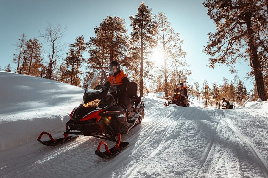 Saariselkä: Snowmobile Ride with Hot Drinks - Following the guide through forests and hills