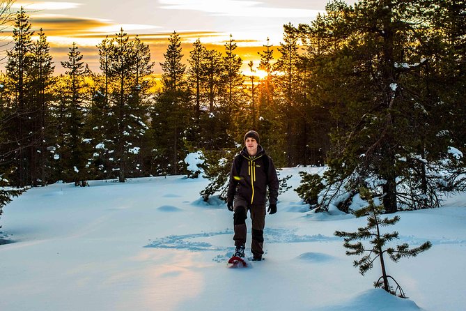 Wilderness snowshoe adventure - Warming up beside the campfire